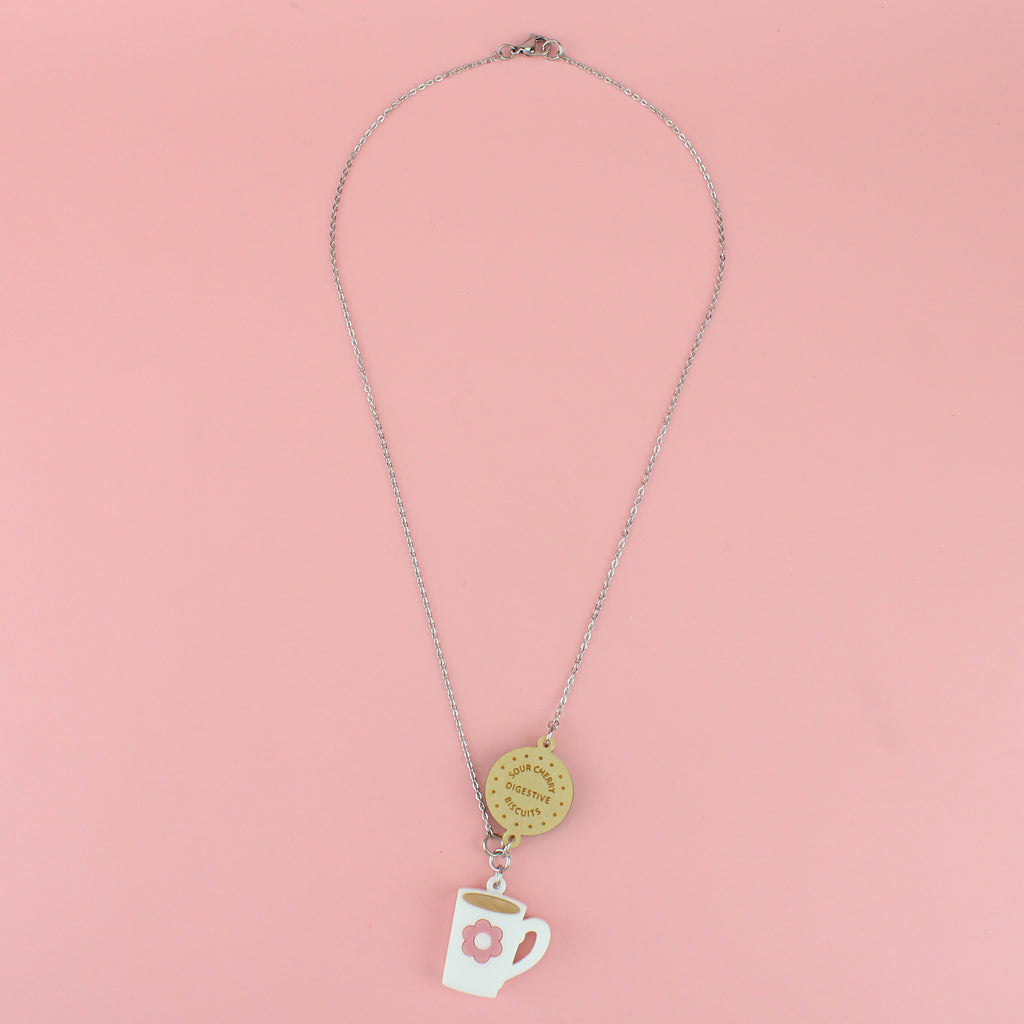 Stainless steel chain with a chocolate digestive pendant reading 'Sour Cherry Digestive Biscuits' and a cup of tea pendant featuring a pink flower design