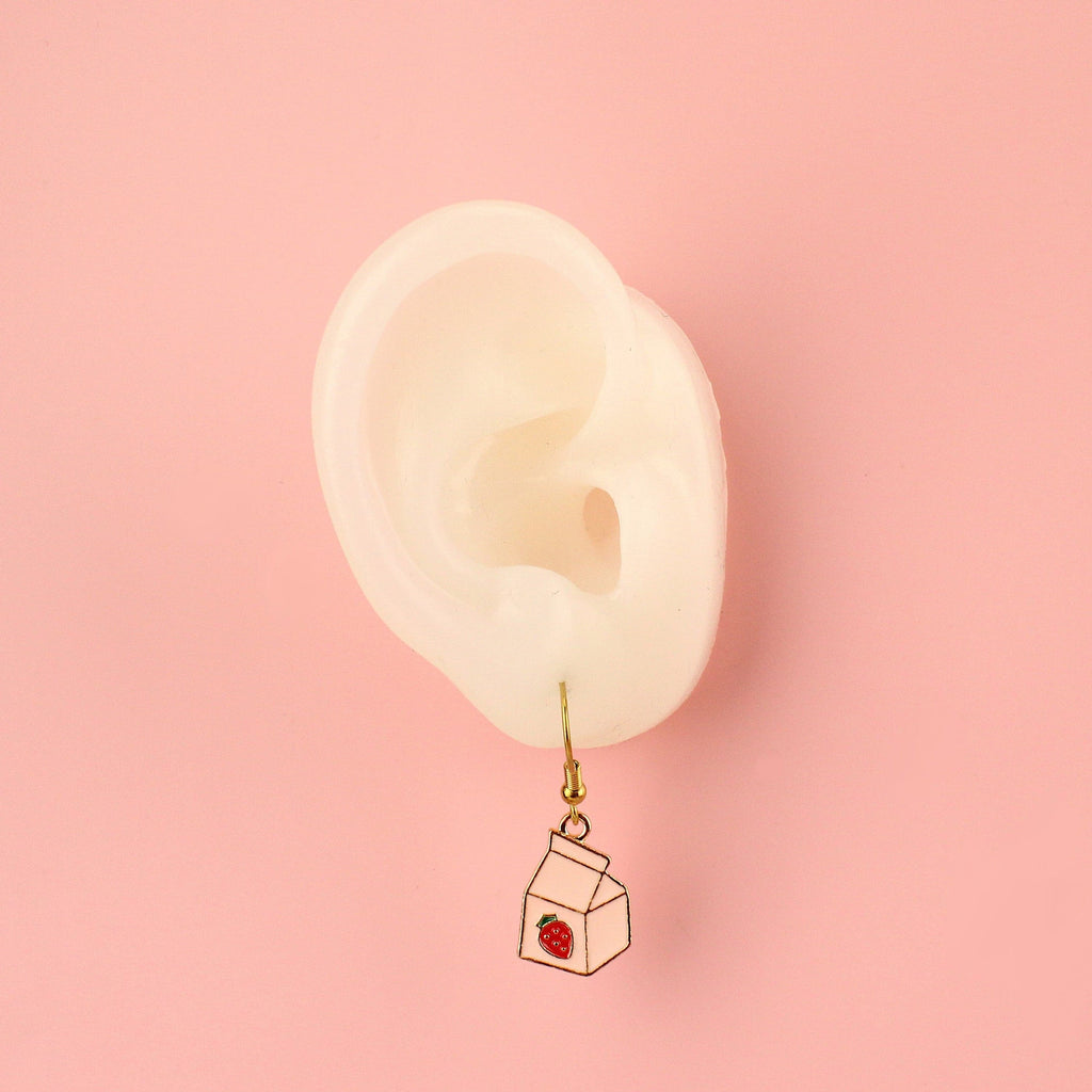 Ear wearing the Strawberry Milk Earrings