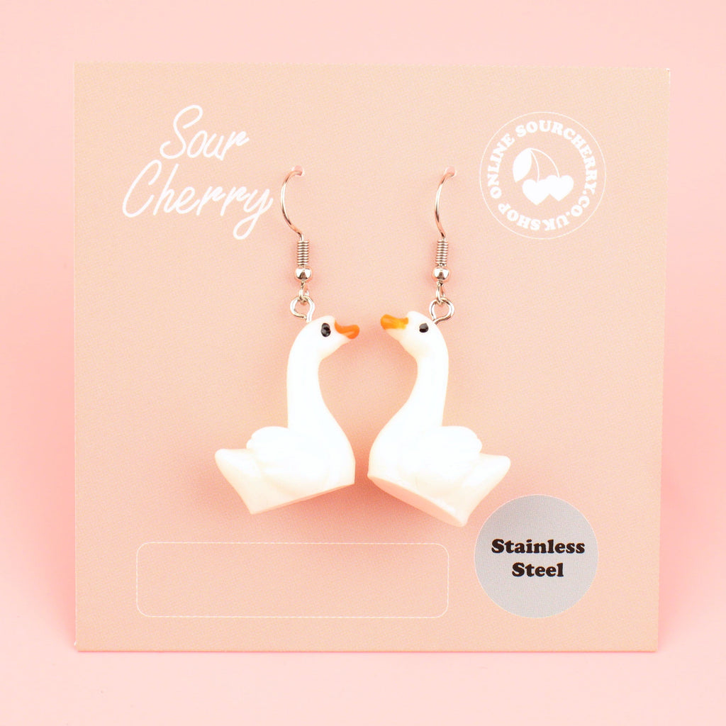 3D resin swan charms on stainless steel earwires shown on the card
