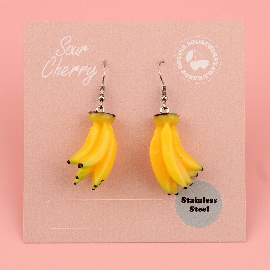 A bunch of resin banana charms on stainless steel earwires shown on the card