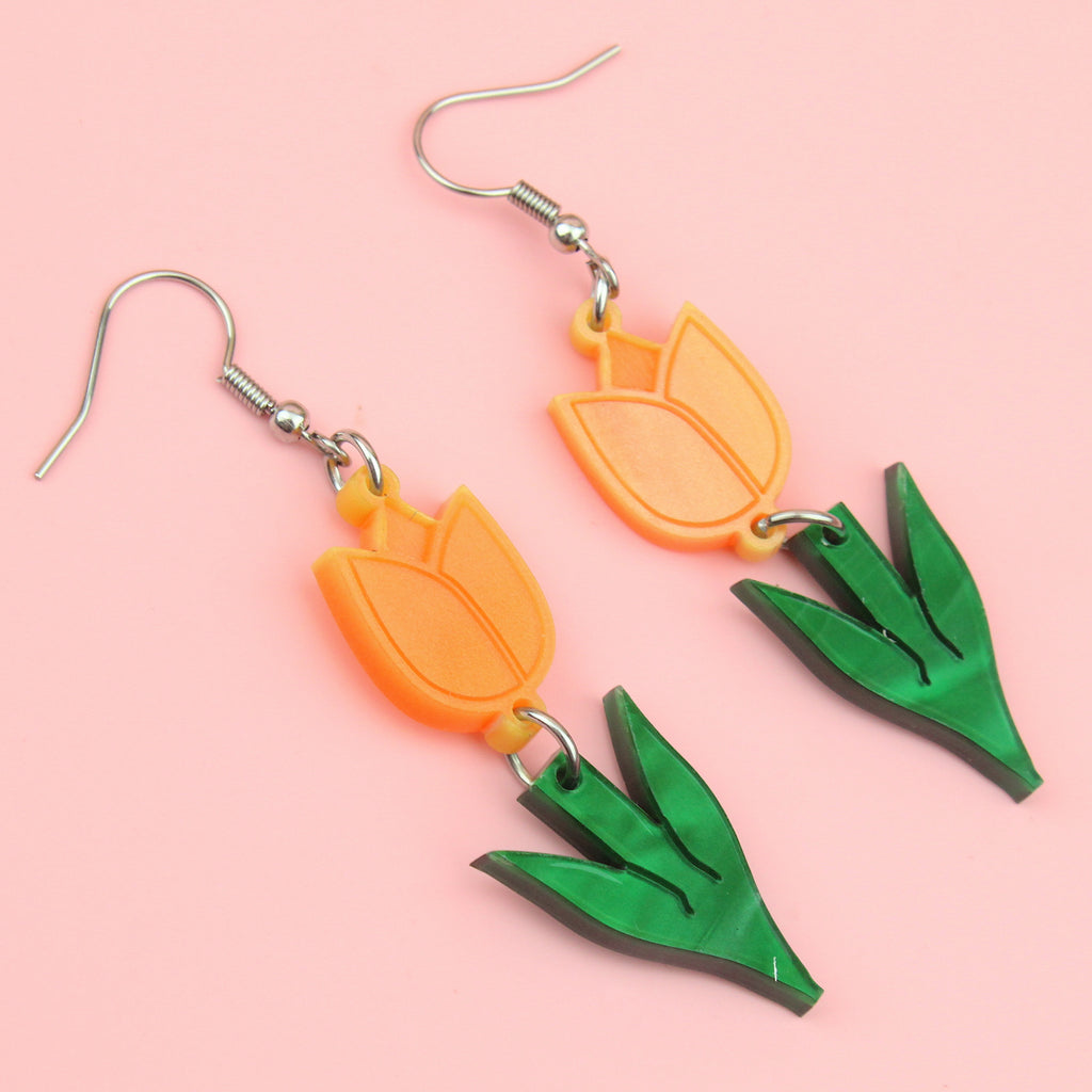 Orange acrylic tulip charms with green stems on stainless steel earwires