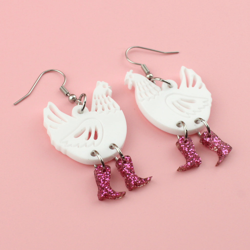 White perspex chicken charms with pink glittery cowboy boots on stainless steel earwires