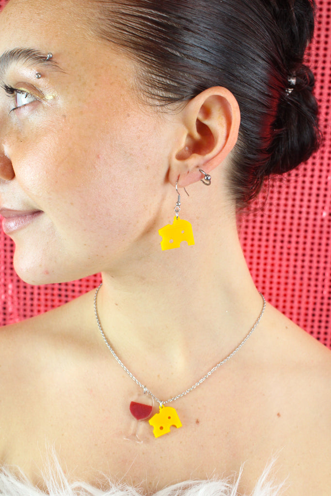 Model wearing one swiss cheese earring with the matching necklace