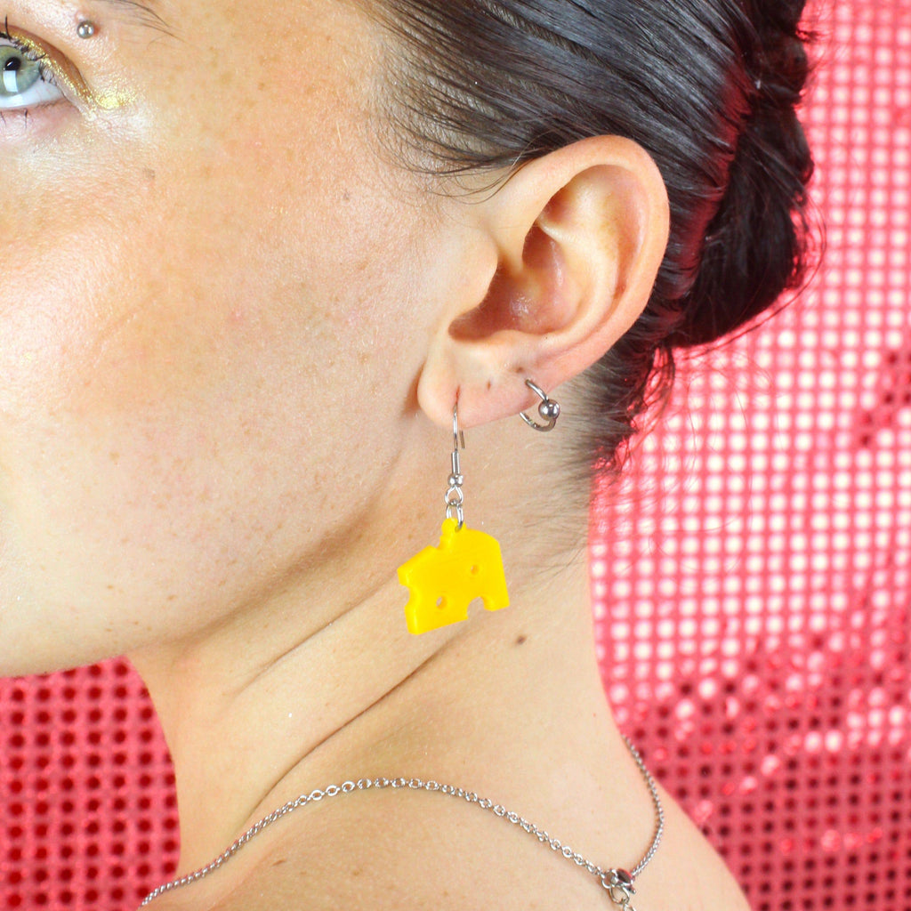 Model wearing swiss cheese earring