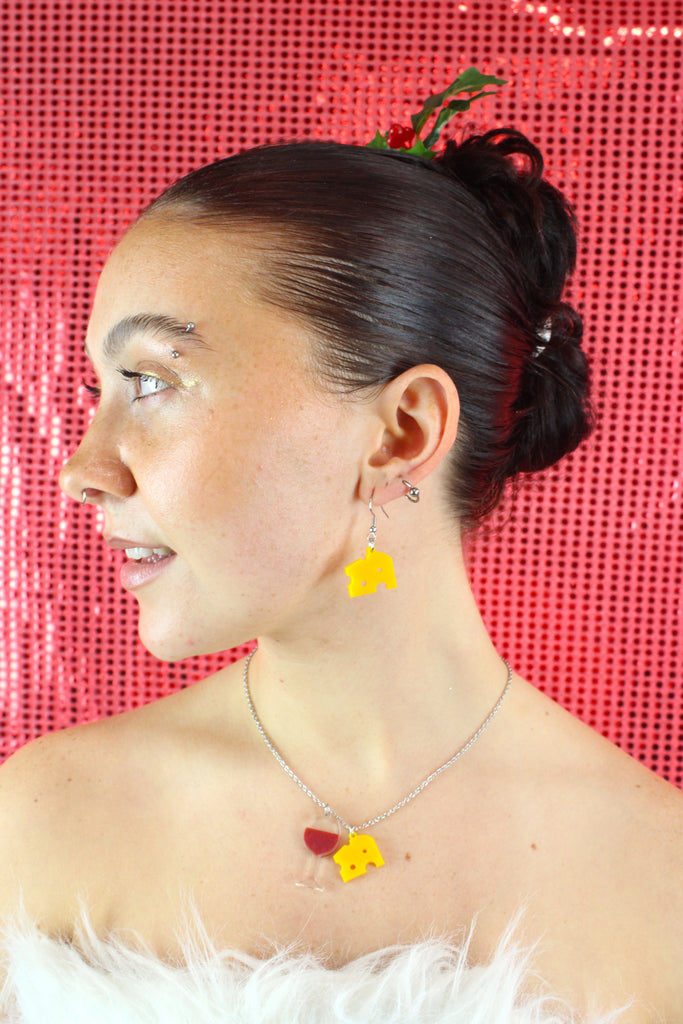 Model wearing stainlesss steel chain with wine and cheese pendants on with the matching earrings