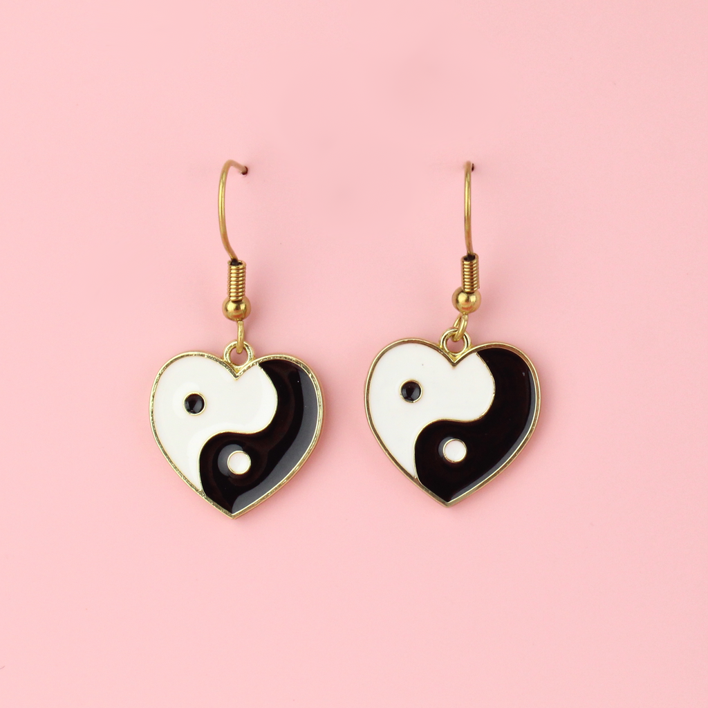 Black and White Yin and Yang charm in the shape of a heart on gold plated stainless steel earwires