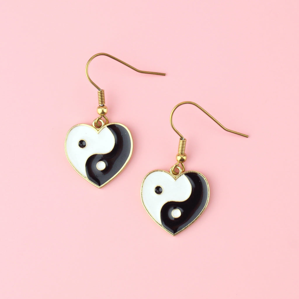 Black and White Yin and Yang charm in the shape of a heart on gold plated stainless steel earwires