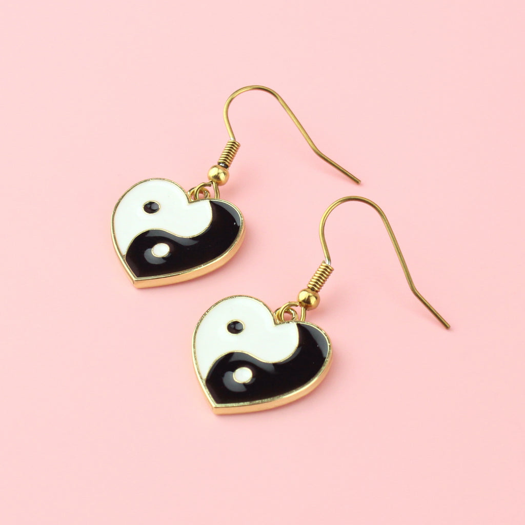 Black and White Yin and Yang charm in the shape of a heart on gold plated stainless steel earwires