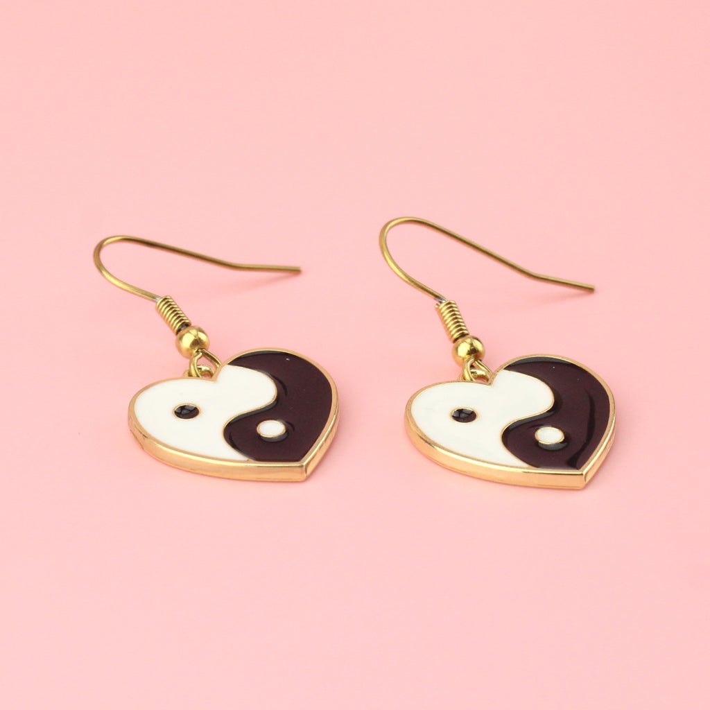 Black and White Yin and Yang charm in the shape of a heart on gold plated stainless steel earwires