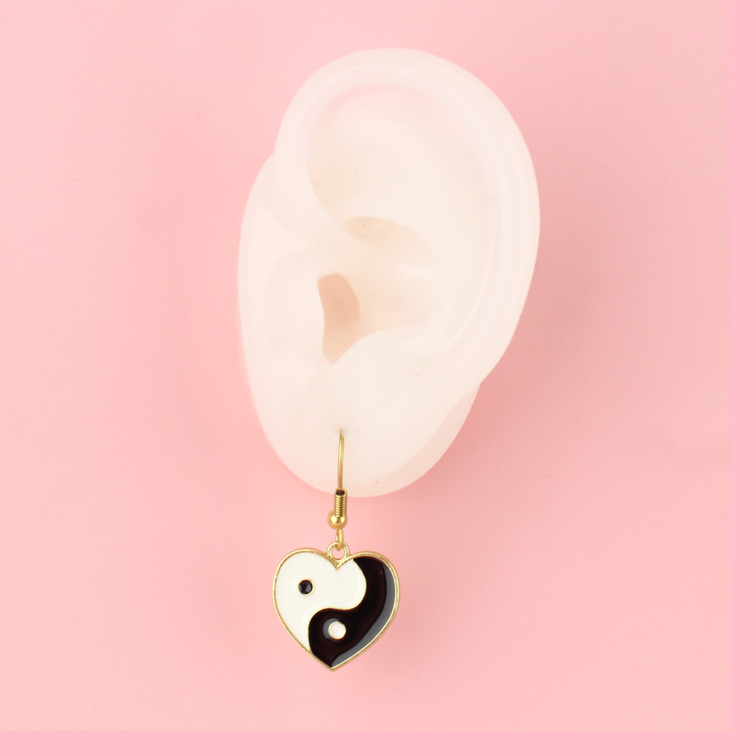 Black and White Yin and Yang charm in the shape of a heart on gold plated stainless steel earwires