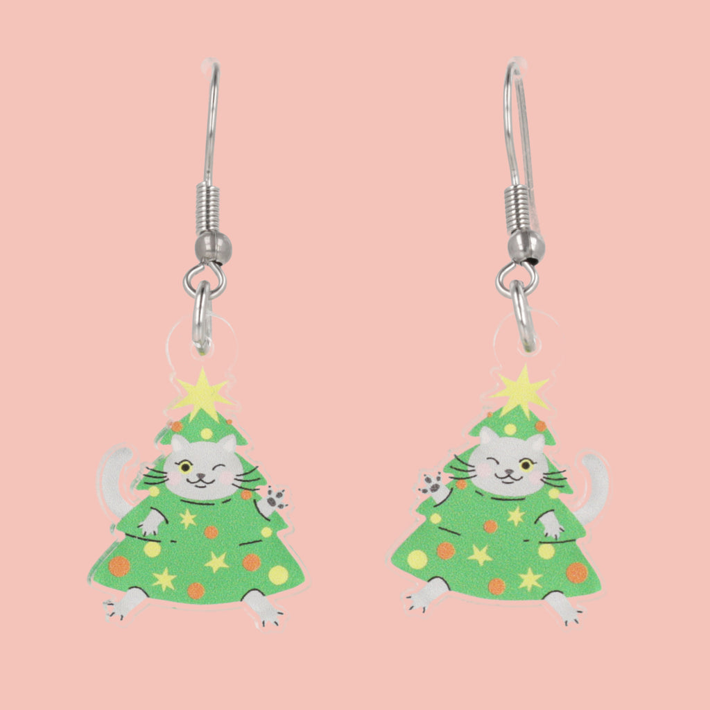 Cat Christmas tree earrings on a pink background