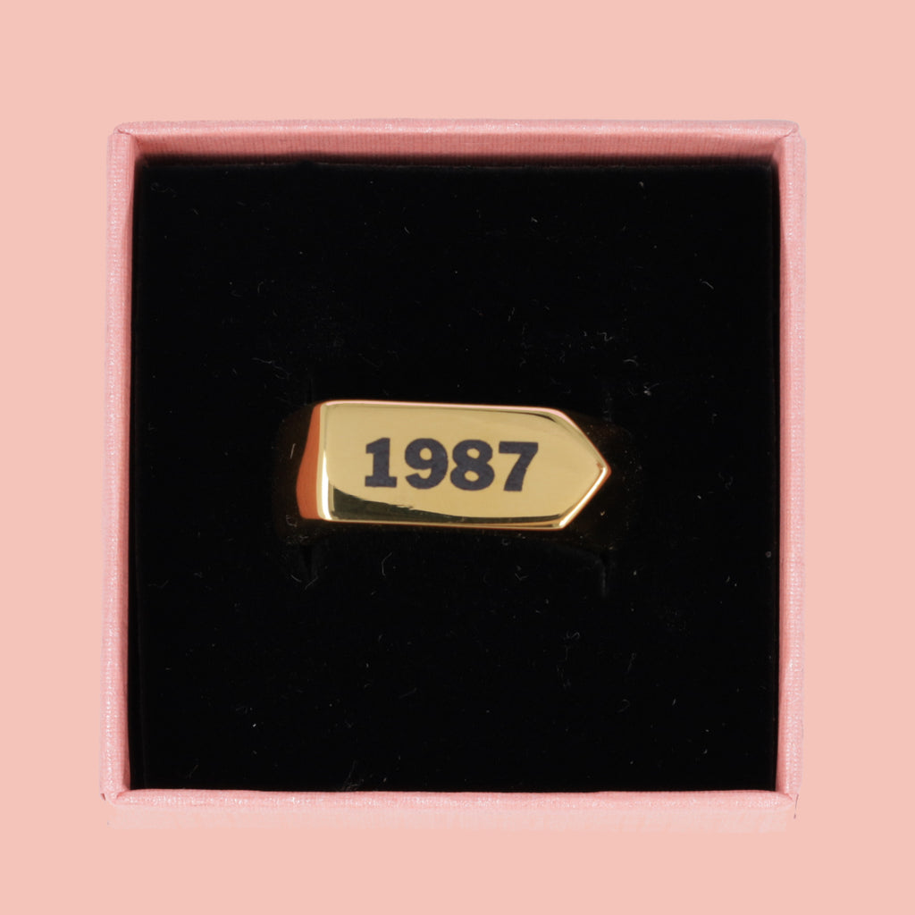 Chunky gold plated stainless steel ring with birth year engraved in black in a gift box