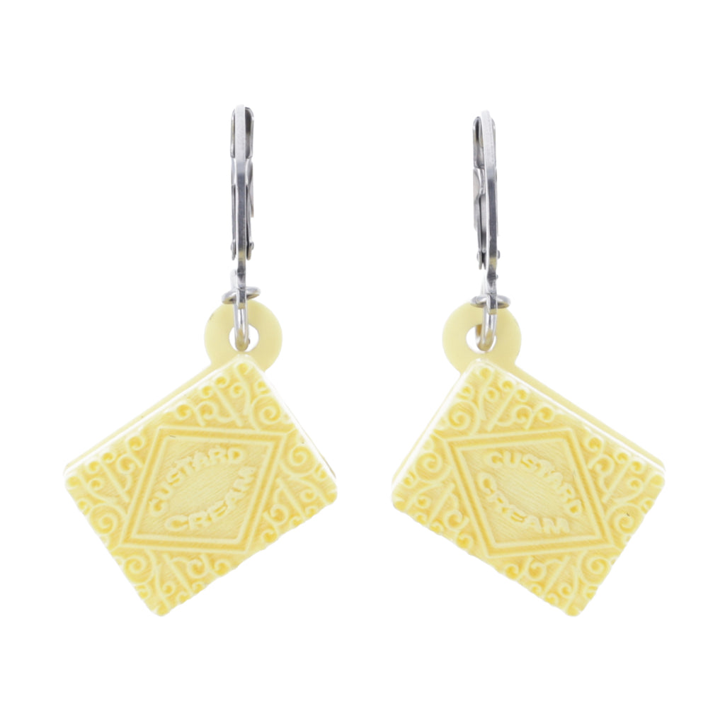 custard cream huggie hoops on a white background