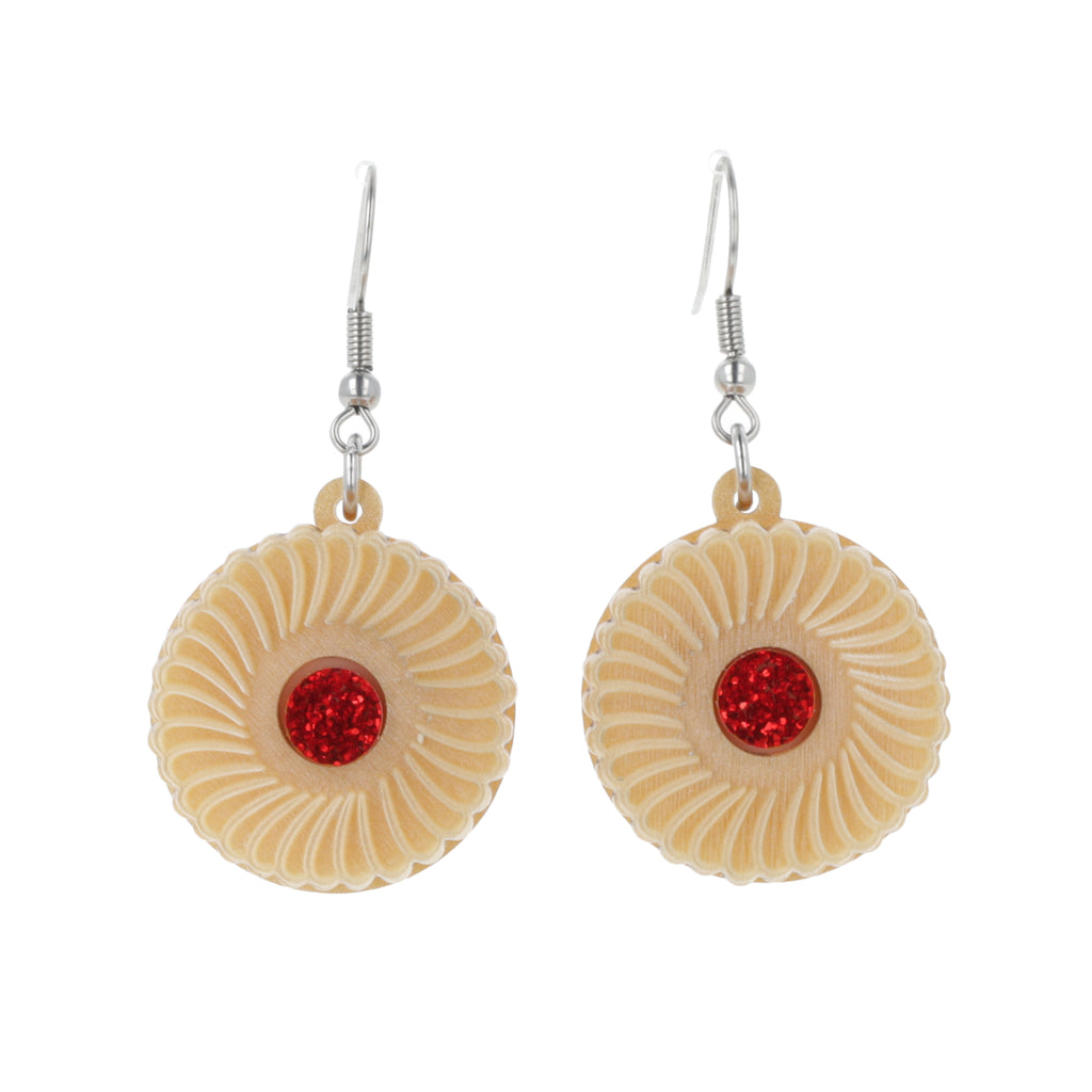 Pair of earrings with jam and cream biscuit charms on a white background