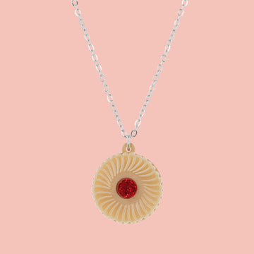 Necklace featuring a pendant of a jam and cream biscuit, on a pink background
