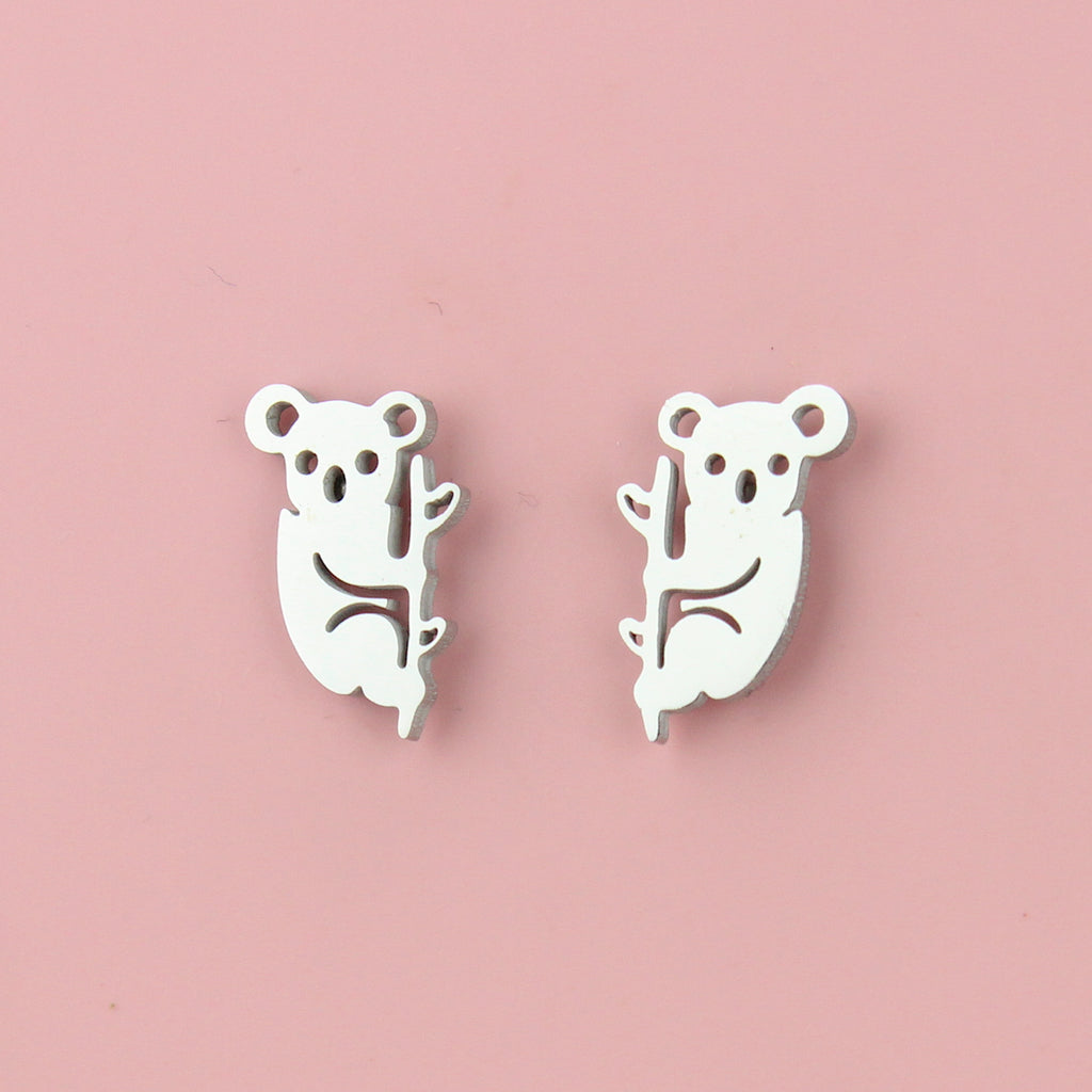Stainless steel studs featuring a cut out koala climbing a tree 