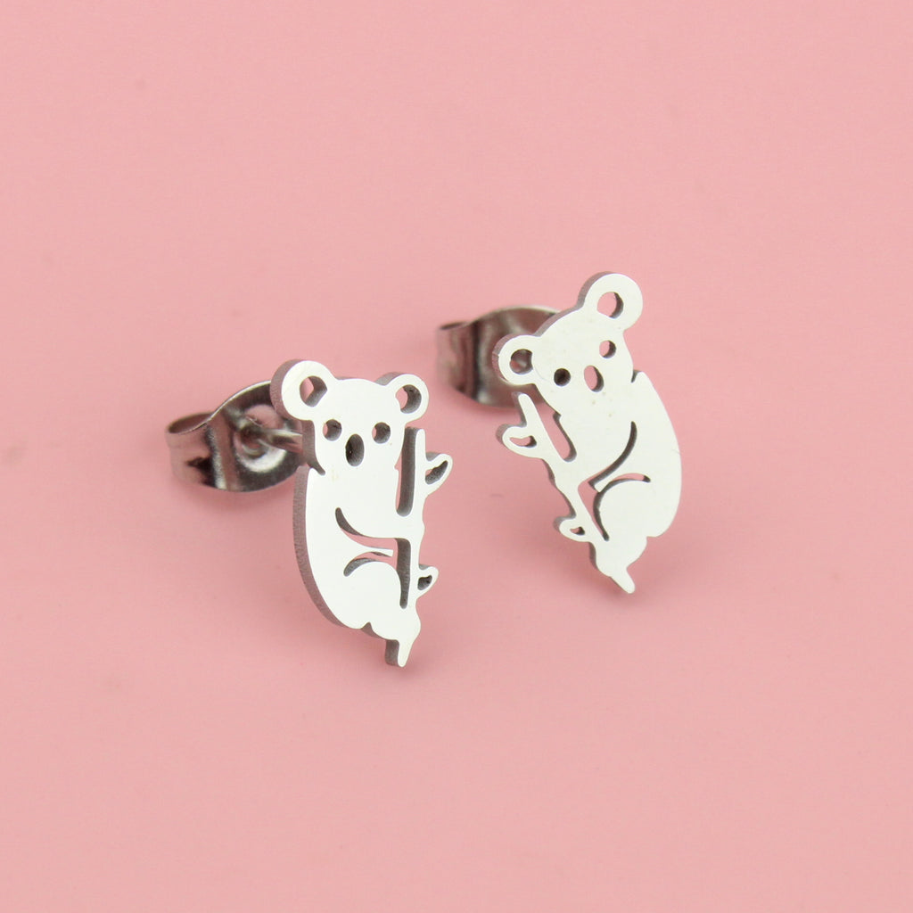 Stainless steel studs featuring a cut out koala climbing a tree