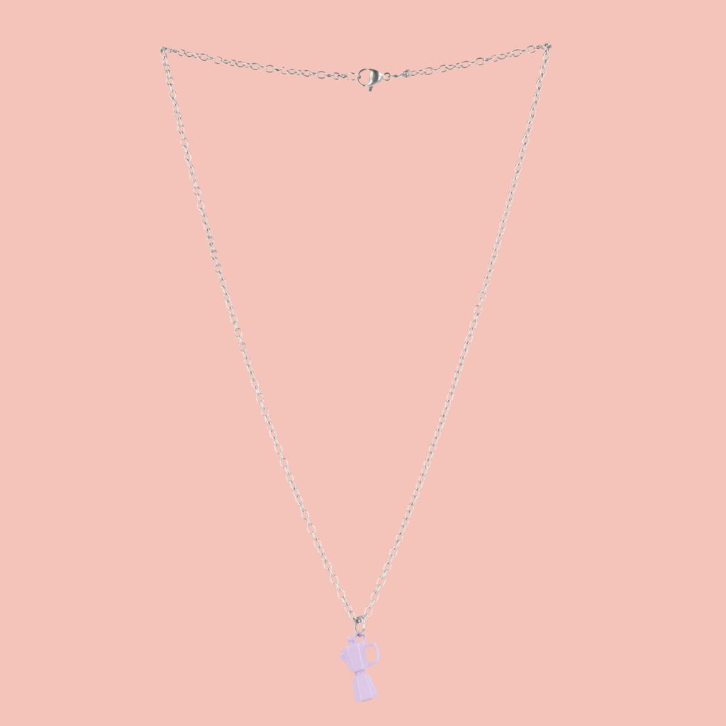 Necklace with a purple coffee pot pendant on a pink background