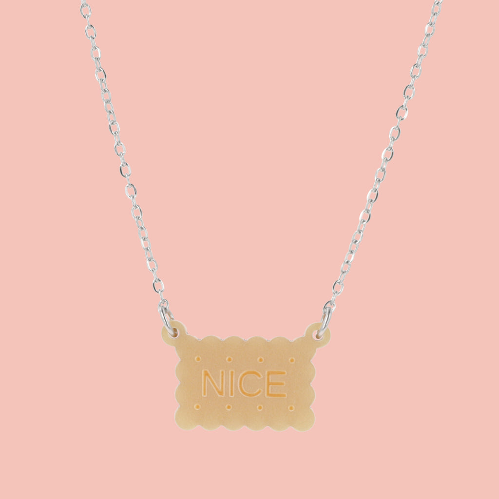 Necklace with a nice biscuit pendant on a pink background