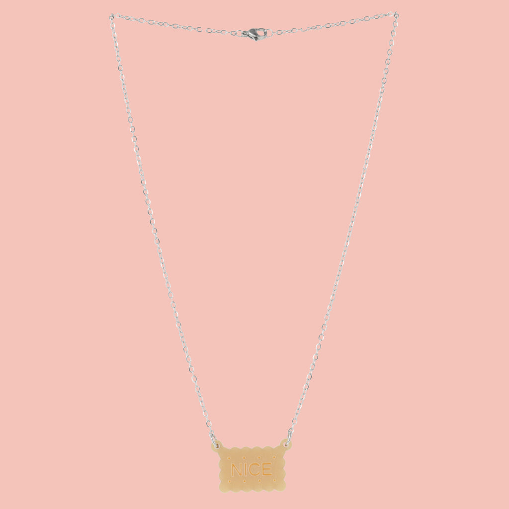 Necklace with a nice biscuit pendant on a pink background