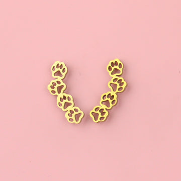 Gold plated stainless steel cut out paw studs featuring four cut out paws making a curved shape