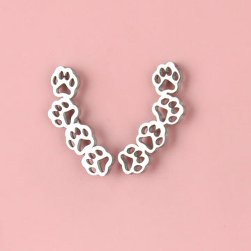 stainless steel cut out paw studs featuring four cut out paws making a curved shape