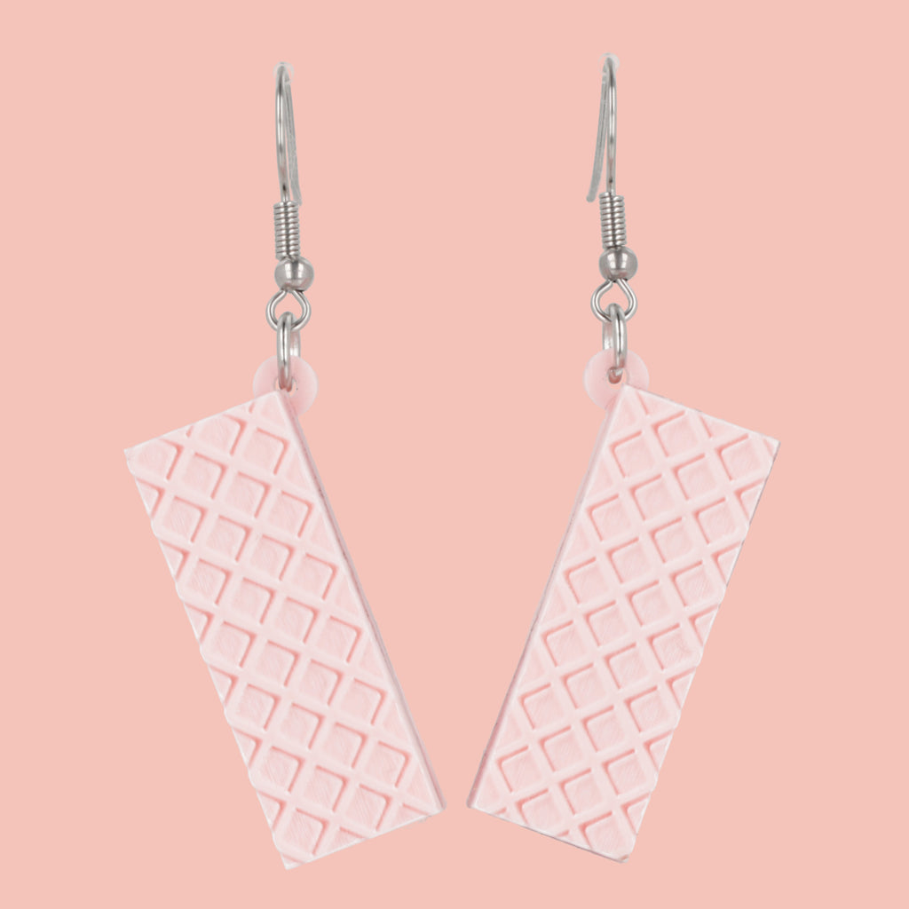 Pair of pink wafer earrings on a pink background