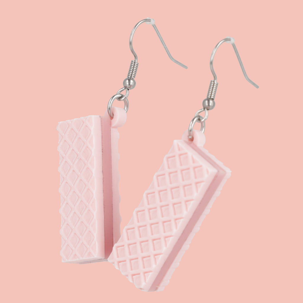 Pair of pink wafer earrings on a pink background