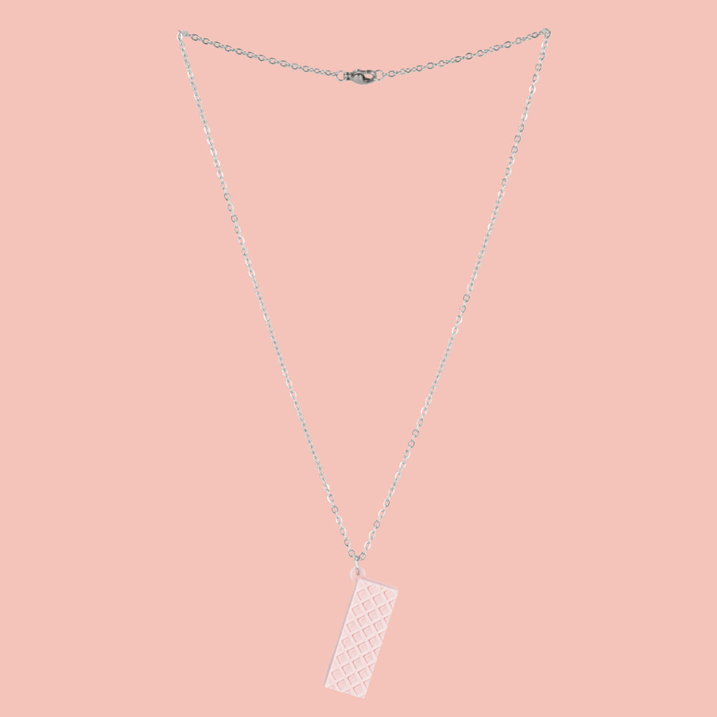 Necklace with a pink wafer pendant on a pink background