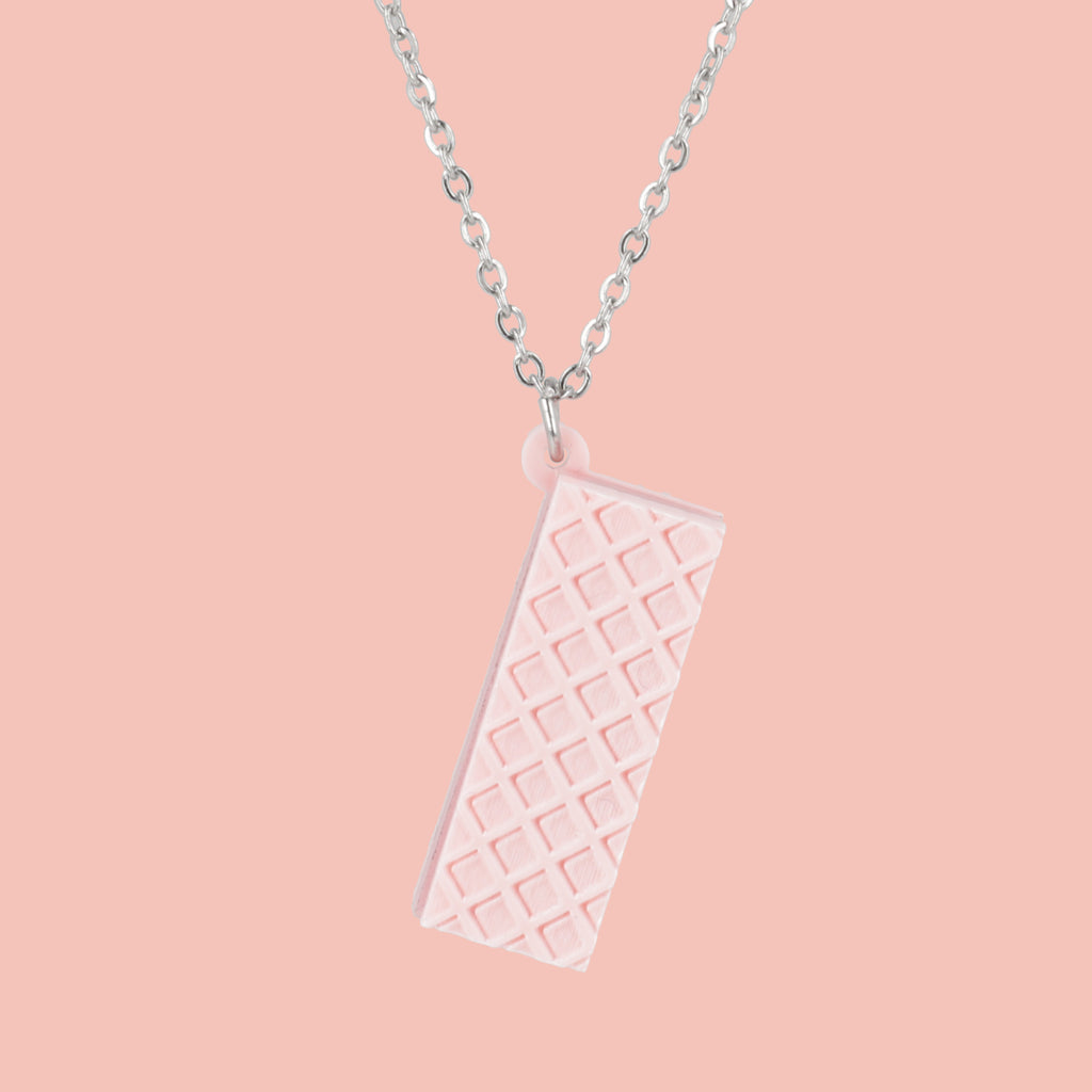 Necklace with a pink wafer pendant on a pink background