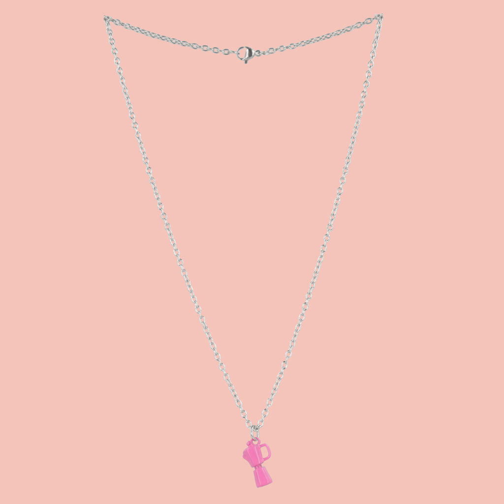 Necklace with a pink coffee pot pendant on a pink background