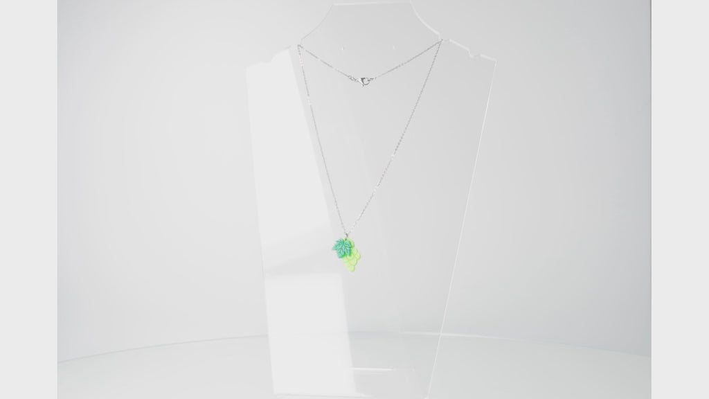 360 view of stainless steel necklace featuring a bunch of green acrylic grapes on a grapevine
