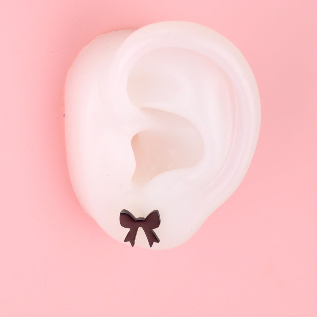 Ear wearing black bow shaped studs stainless steel studs