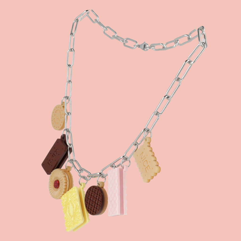 Necklace with cookie charms on a pink background