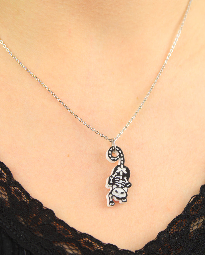 model wearing cat skeleton pendant on a stainless steel chain 