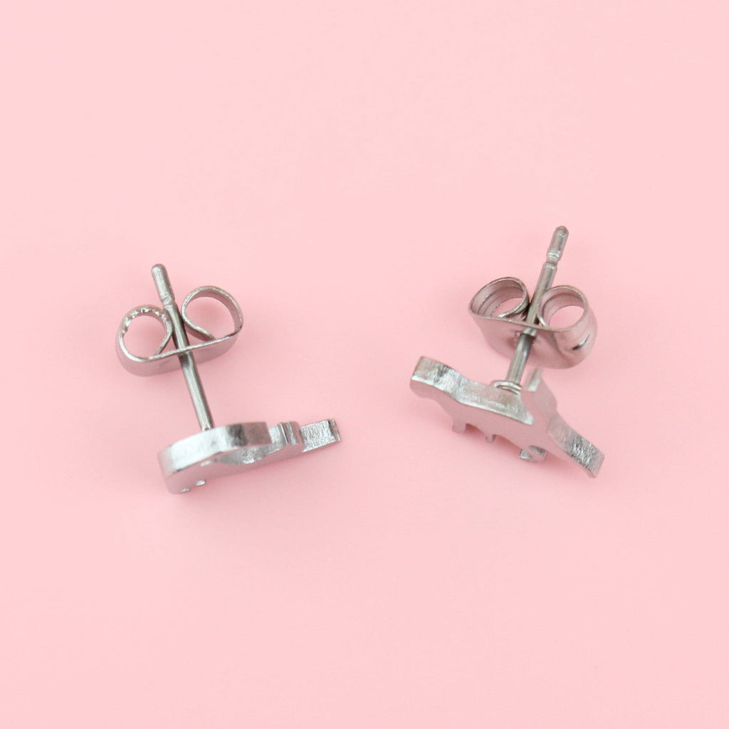 Stainless steel studs that show two cats stretching