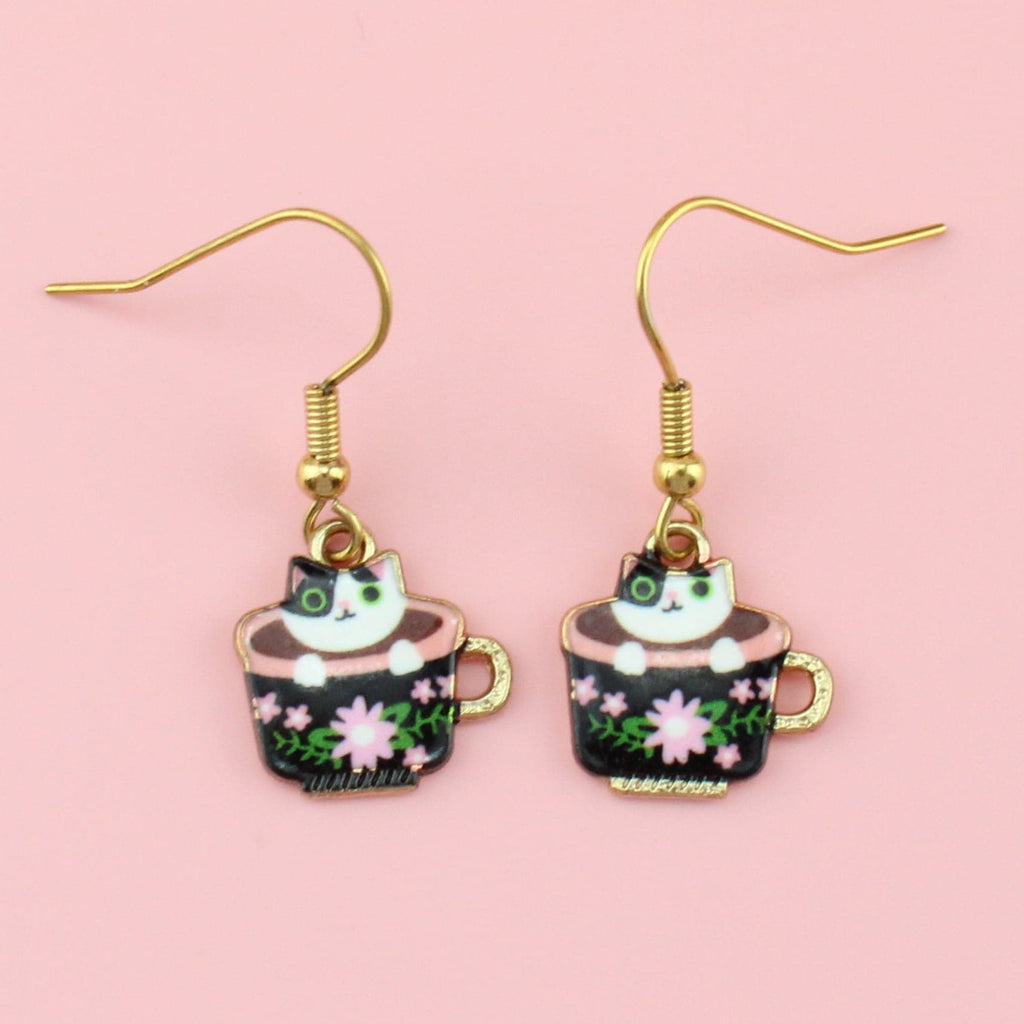 Charms featuring Black and White Cat in a black teacup with pink flower detailing on them and a gold handle on gold plated stainless steel earwires