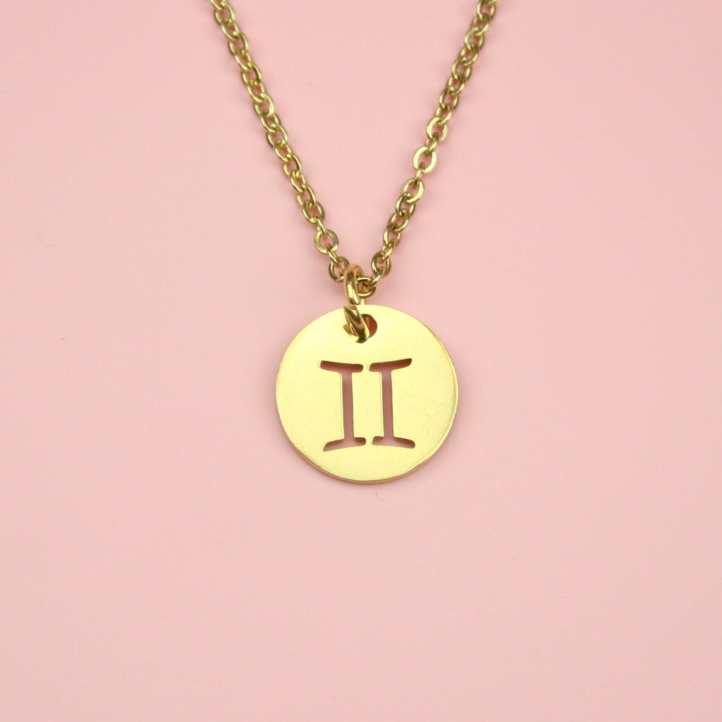 Gold Plated Circle Charm with Cut Out Gemini Symbol on a Gold plated Stainless Steel chain
