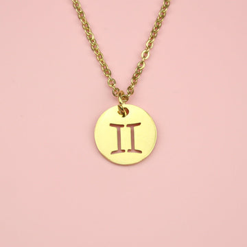 Gold Plated Circle Charm with Cut Out Gemini Symbol on a Gold plated Stainless Steel chain