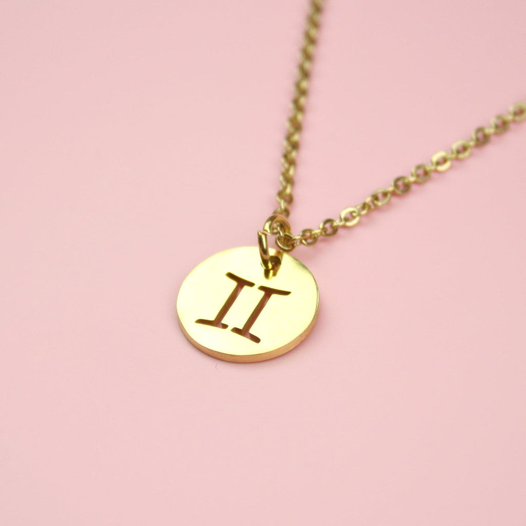 Gold Plated Circle Charm with Cut Out Gemini Symbol on a Gold plated Stainless Steel chain
