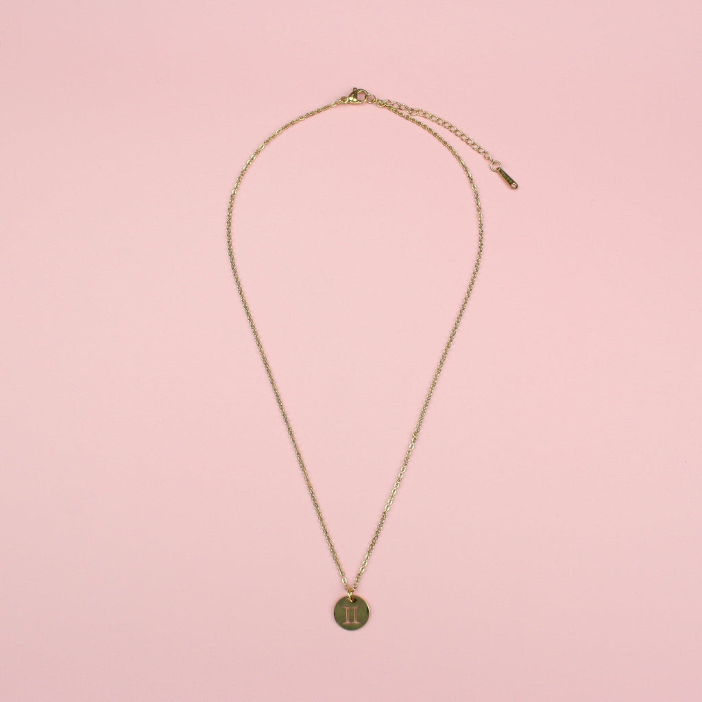 Gold Plated Circle Charm with Cut Out Gemini Symbol on a Gold plated Stainless Steel chain