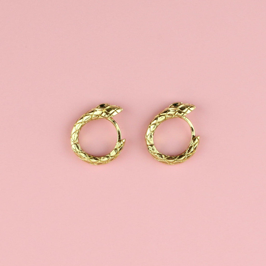 Gold plated snake hoop earrings featuring green cubic zirconia eyes