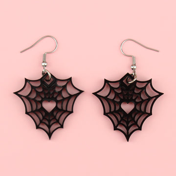 Black perspex spider web charms on stainless steel earwires with a cut out spiders web and heart centre