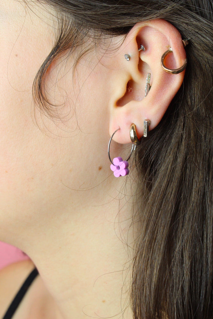 Ear wearing the silve hoop with the pink flower charm