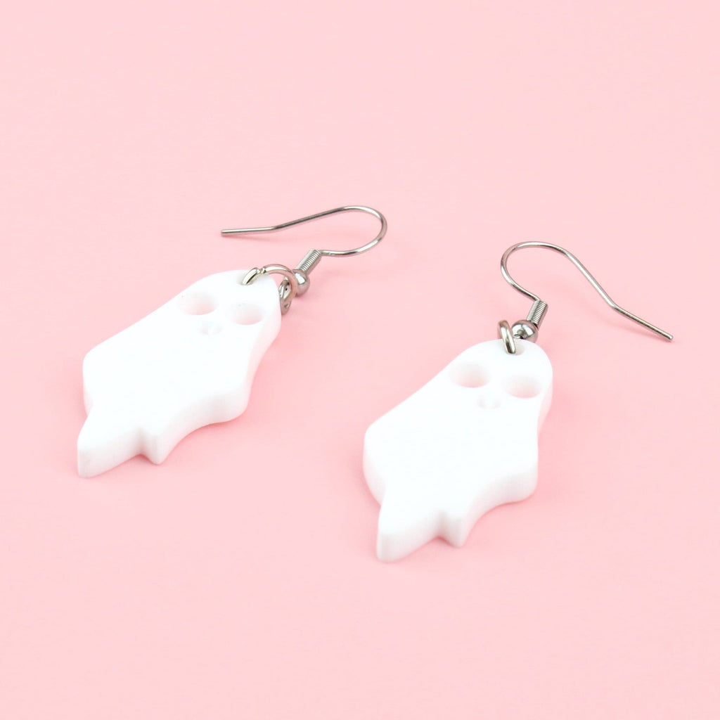 White acrylic ghost charms with cut out eyes and mouth on stainless steel earwires