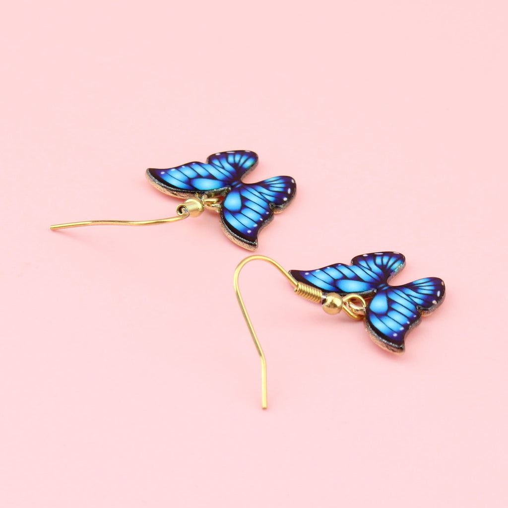 Bright blue butterfly charms on gold plated stainless steel earwires