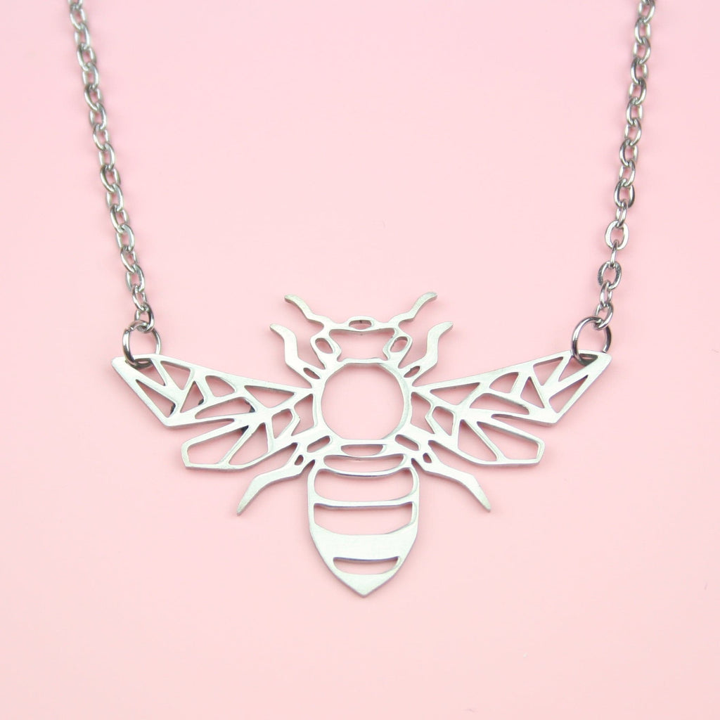 Cut out bee pendant on a stainless steel chain.
