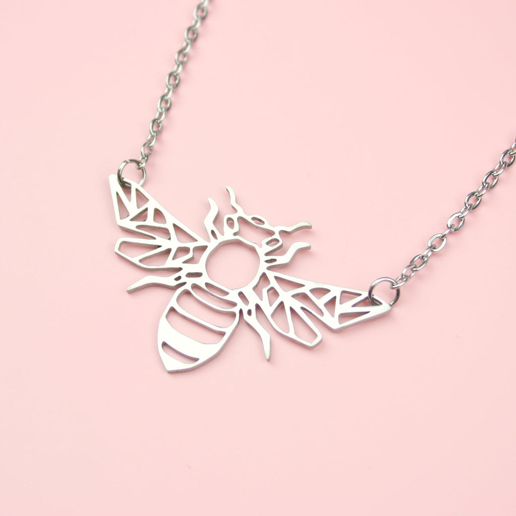 Cut out bee pendant on a stainless steel chain.