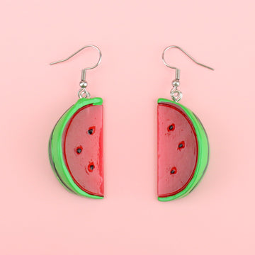Slices of watermelon on stainless steel earwires