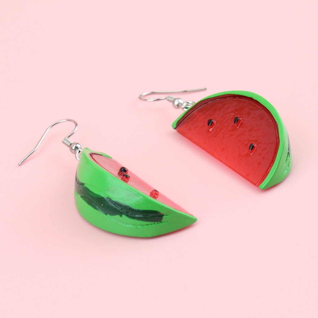 Slices of watermelon on stainless steel earwires